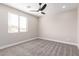 Bedroom features a ceiling fan, plush carpeting, neutral walls and well lit windows at 13012 S 218Th Ave, Buckeye, AZ 85326