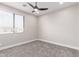Bedroom features a ceiling fan, plush carpeting, neutral walls and well lit windows at 13012 S 218Th Ave, Buckeye, AZ 85326
