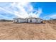 Contemporary home with a clean white exterior, desert landscape, and a side view under a bright sky at 13012 S 218Th Ave, Buckeye, AZ 85326