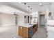 Open kitchen featuring a large island, white cabinets, stainless steel appliances, and seamless access to the living space at 13012 S 218Th Ave, Buckeye, AZ 85326