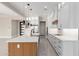 Modern kitchen with white cabinets, quartz countertops, a wood island, and stainless steel appliances at 13012 S 218Th Ave, Buckeye, AZ 85326