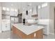 Stylish kitchen featuring white cabinetry, a spacious island, and modern stainless steel appliances at 13012 S 218Th Ave, Buckeye, AZ 85326