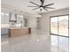 Open-concept layout featuring a modern kitchen and living area with bright tile floors and a sliding door at 13012 S 218Th Ave, Buckeye, AZ 85326