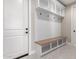 Bright mudroom features a built-in bench with storage, hooks, and overhead shelving for organization at 13012 S 218Th Ave, Buckeye, AZ 85326