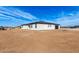 Wide rear exterior of modern home with stucco walls, tile roof, and black trim at 13012 S 218Th Ave, Buckeye, AZ 85326