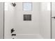 Modern tiled shower with matte black fixtures and built-in niche in remodeled bathroom at 13012 S 218Th Ave, Buckeye, AZ 85326