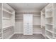 Spacious walk-in closet with built in shelving, drawers and white cabinets for optimal storage solutions at 13012 S 218Th Ave, Buckeye, AZ 85326