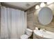 Bathroom with a round mirror and shower featuring tiled walls and floors at 1320 E Bethany Home Rd # 24, Phoenix, AZ 85014