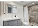 Bathroom with a gray vanity and shower featuring tiled walls and floors at 1320 E Bethany Home Rd # 24, Phoenix, AZ 85014