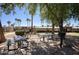 Community area with multiple picnic tables, charcoal grills, and mature shade trees at 1320 E Bethany Home Rd # 24, Phoenix, AZ 85014
