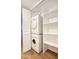 Laundry closet with stackable washer and dryer and shelving unit at 1320 E Bethany Home Rd # 24, Phoenix, AZ 85014
