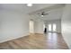 Bright living room with wood-look floors, ceiling fan, and access to the kitchen and patio at 1320 E Bethany Home Rd # 24, Phoenix, AZ 85014