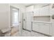 Well-lit laundry room with white cabinets, countertops, patterned floor tiles, and modern appliances at 1321 W Shellfish Dr, Gilbert, AZ 85233