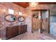 Beautiful bathroom with brick walls, wood floors, a decorative ceiling, and double sink vanity at 15128 E Westridge Dr, Fountain Hills, AZ 85268