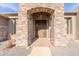 Charming home exterior with a stone archway and decorative front door, offering curb appeal at 15128 E Westridge Dr, Fountain Hills, AZ 85268