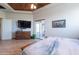 Bright main bedroom offering wood floors, a view of a large dresser, and sliding glass doors at 15128 E Westridge Dr, Fountain Hills, AZ 85268