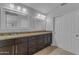 Bright bathroom with double sinks, granite countertop, and dark wood cabinets at 16002 N 50Th St, Scottsdale, AZ 85254