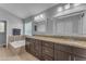 Spacious bathroom with double sinks, granite counters, dark cabinets and a tub at 16002 N 50Th St, Scottsdale, AZ 85254