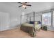 Bedroom featuring a ceiling fan, four-poster bed with cozy bedding, and a large window at 16002 N 50Th St, Scottsdale, AZ 85254