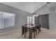 Bright dining room with a wooden table, modern lighting and window views at 16002 N 50Th St, Scottsdale, AZ 85254
