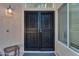 Close-up of a secure, decorative wrought iron front door with side window at 16002 N 50Th St, Scottsdale, AZ 85254