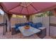 Relax in this cozy outdoor gazebo featuring comfortable seating and a stylish table, perfect for entertaining guests at 16002 N 50Th St, Scottsdale, AZ 85254