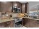 Well-equipped kitchen with stainless steel appliances, granite countertops, and stylish backsplash at 16002 N 50Th St, Scottsdale, AZ 85254