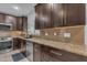 Close up of modern kitchen featuring stainless steel appliances, granite countertops and a tile backsplash at 16002 N 50Th St, Scottsdale, AZ 85254