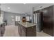 Kitchen with a center island, stainless steel appliances, and view into the living area at 16002 N 50Th St, Scottsdale, AZ 85254