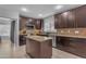 Modern kitchen with dark cabinets, stainless steel appliances and center island for food prep at 16002 N 50Th St, Scottsdale, AZ 85254