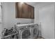 Modern laundry room featuring a washer, dryer, built in storage and a utility sink at 16002 N 50Th St, Scottsdale, AZ 85254