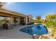 Inviting backyard oasis featuring a private pool, patio, and lush landscaping at 16528 W Isleta Ct, Surprise, AZ 85387