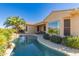Beautiful backyard showcasing a sparkling pool, patio area, and desert plants at 16528 W Isleta Ct, Surprise, AZ 85387