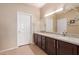 Bathroom featuring granite counters, double sinks and tile flooring at 16528 W Isleta Ct, Surprise, AZ 85387
