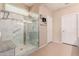 Well-lit bathroom featuring a glass shower with tiled walls and a built-in bench at 16528 W Isleta Ct, Surprise, AZ 85387