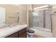 Bathroom featuring glass door shower, granite counters and vanity at 16528 W Isleta Ct, Surprise, AZ 85387