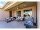 Comfortable outdoor living with a covered patio, plush seating, and a built-in barbecue area at 16528 W Isleta Ct, Surprise, AZ 85387