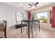 Bright dining area featuring tile floors, ceiling fan and bay window to backyard at 16528 W Isleta Ct, Surprise, AZ 85387