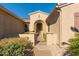 Welcoming front entrance with a gated courtyard and arched doorway at 16528 W Isleta Ct, Surprise, AZ 85387