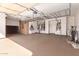 Spacious garage with ceiling storage racks, built-in cabinets and clean epoxy flooring at 16528 W Isleta Ct, Surprise, AZ 85387