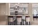 Open-concept kitchen featuring a breakfast bar and sleek appliances at 16528 W Isleta Ct, Surprise, AZ 85387