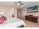 Neutral main bedroom featuring ceiling fan and access door to the exterior at 16528 W Isleta Ct, Surprise, AZ 85387