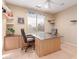 Office with a ceiling fan and large desk at 16528 W Isleta Ct, Surprise, AZ 85387