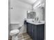Dual sink bathroom featuring dark cabinets and stone countertops at 1716 W Butler Dr, Phoenix, AZ 85021