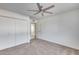Bedroom featuring ceiling fan, closet, and neutral carpet at 1716 W Butler Dr, Phoenix, AZ 85021