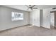Bedroom with a large window, ceiling fan and carpet at 1716 W Butler Dr, Phoenix, AZ 85021