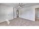 Bedroom featuring a ceiling fan, carpeted floors, and multiple doorways at 1716 W Butler Dr, Phoenix, AZ 85021