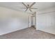 Bedroom featuring ceiling fan, closet, and neutral carpet at 1716 W Butler Dr, Phoenix, AZ 85021