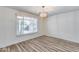 Bright dining room featuring hardwood floors, a modern chandelier, and natural light at 1716 W Butler Dr, Phoenix, AZ 85021