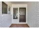 Inviting entryway with tiled flooring, brick walls, and a decorative front door at 1716 W Butler Dr, Phoenix, AZ 85021